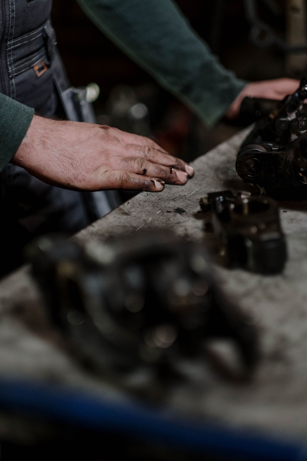 Mechanic inspecting engine parts in workshop